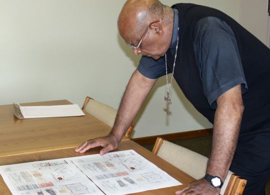 Cardinal Wilfrid Napier checks the plans for a new church