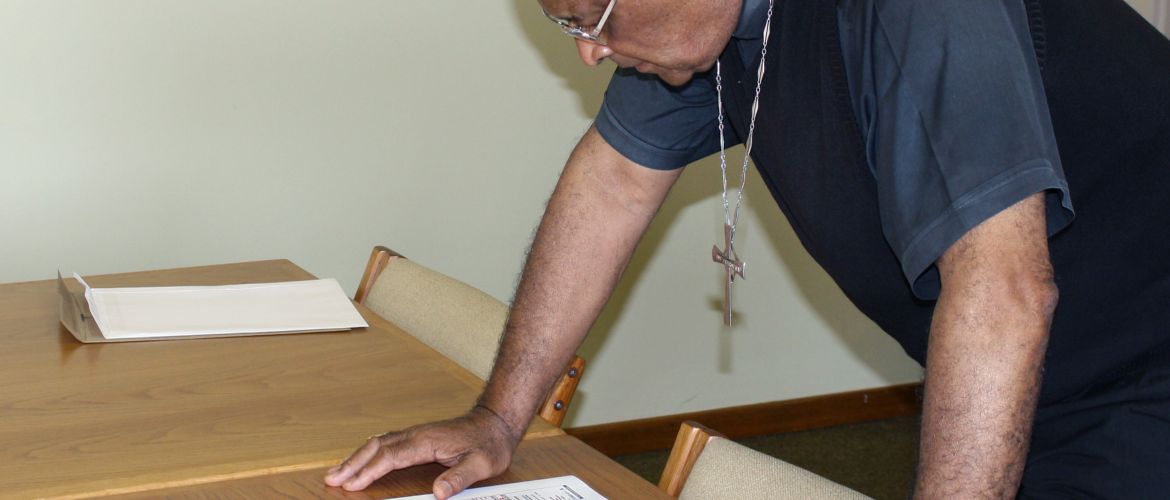 Cardinal Wilfrid Napier checks the plans for a new church